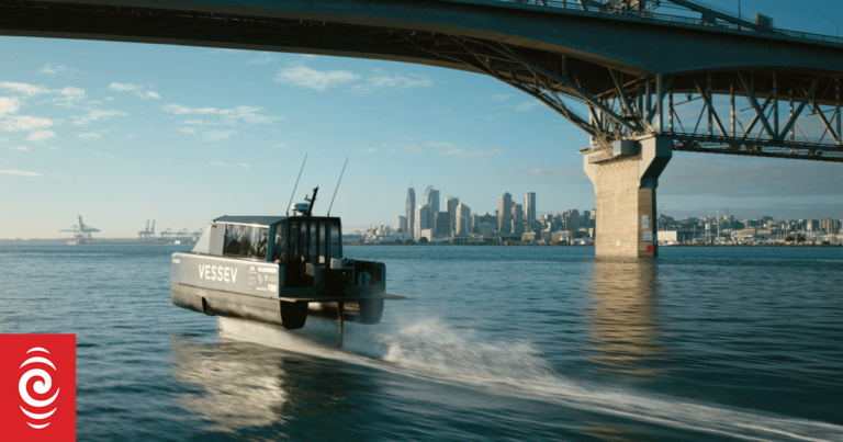 Vessev VS-9 high-speed electric hydrofoiling boat gliding under Auckland Bridge with the city skyline in the background.