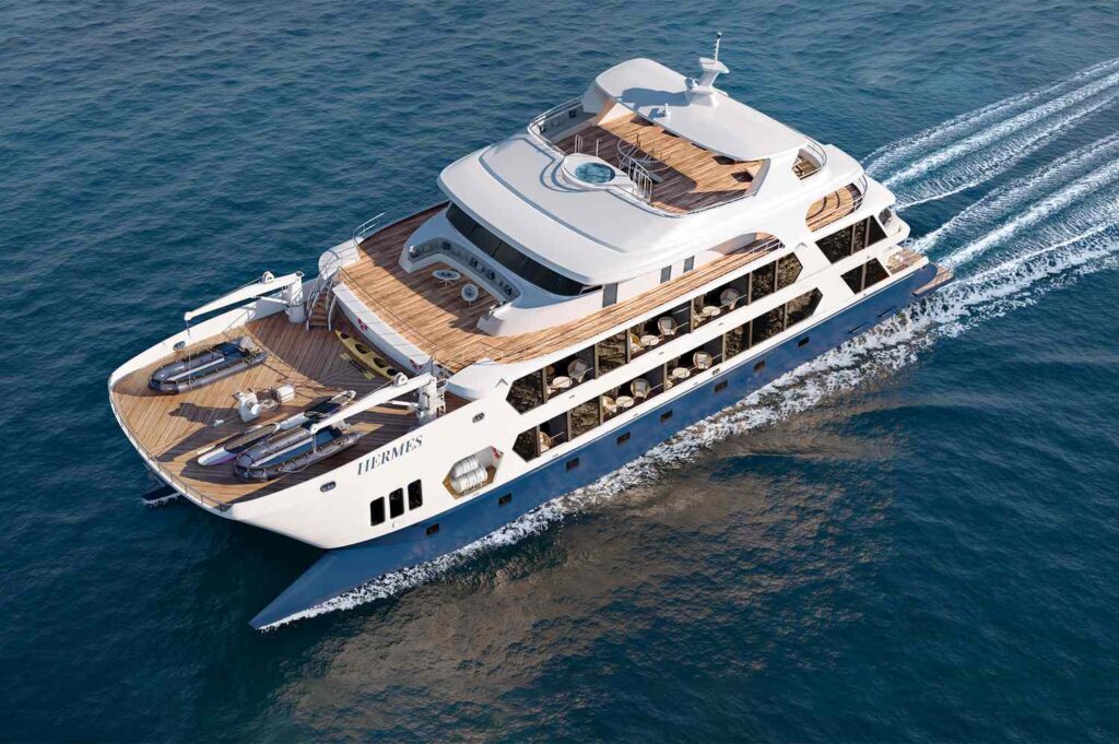 Luxury Hermes catamaran cruising through the Galápagos Islands with spacious decks, modern amenities, and panoramic ocean views.