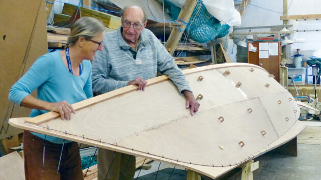 Hanneke Boon and James Wharram looking at a boat under construction