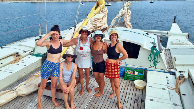 Women standing on the deck of a boat